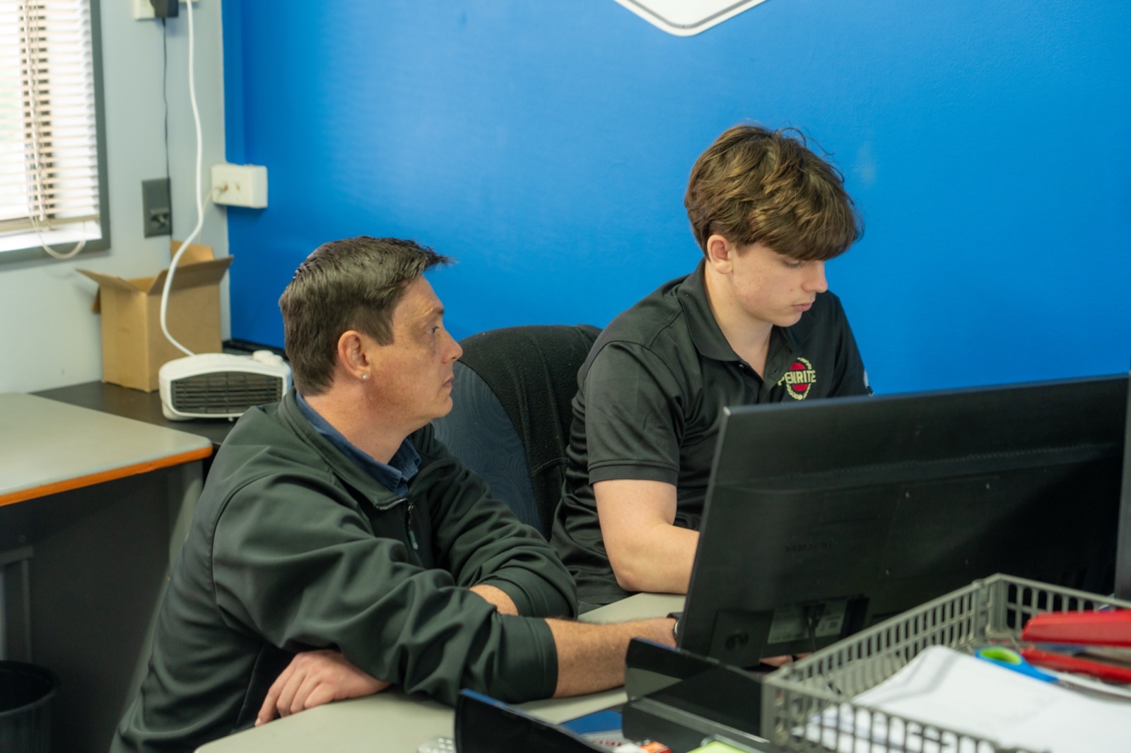 Senior Turbo & Diesel technician and apprentice working through diagnostics together.